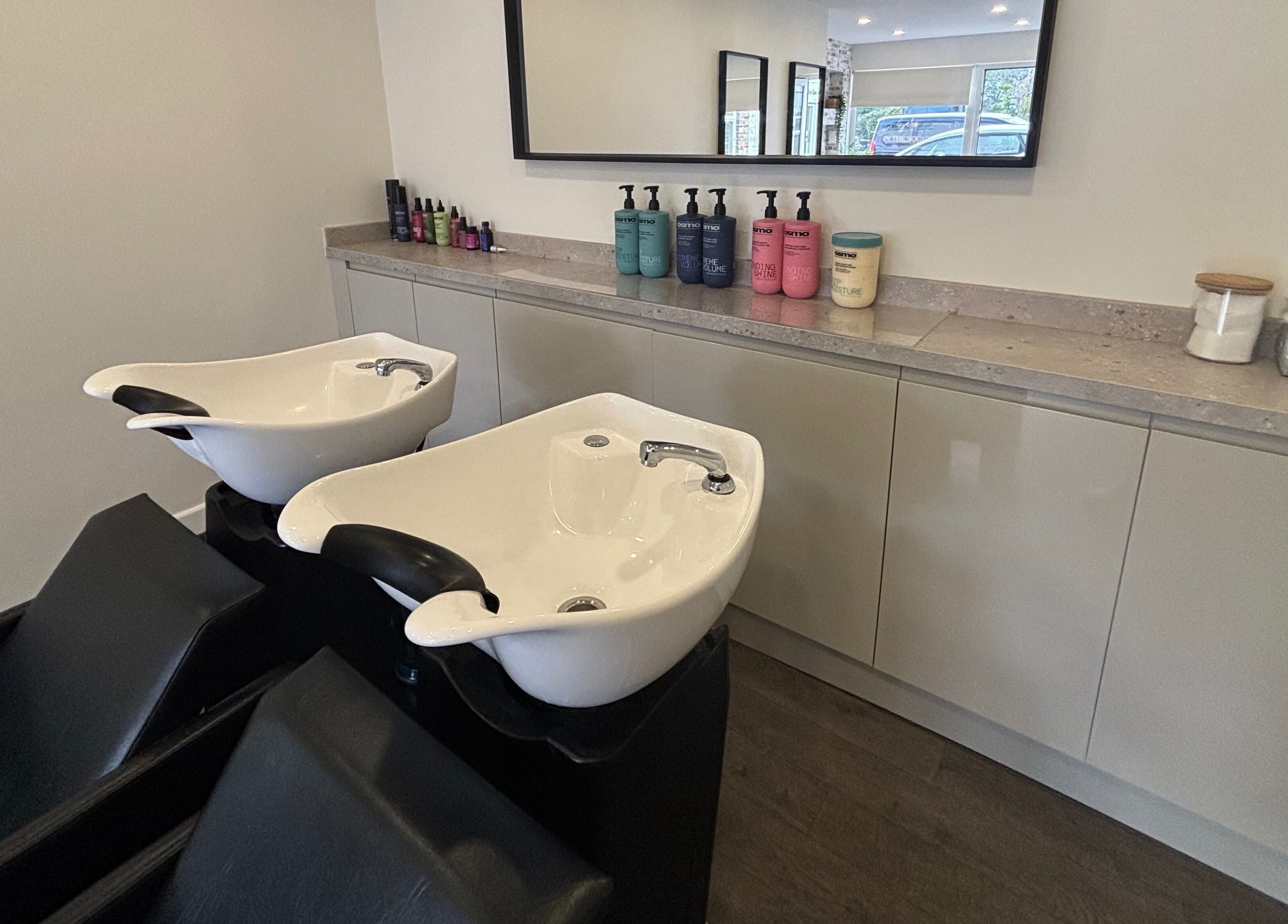 Modern wash stations at Salon In The Square, Mawnan Smith, England, GB, offering luxury haircare services.