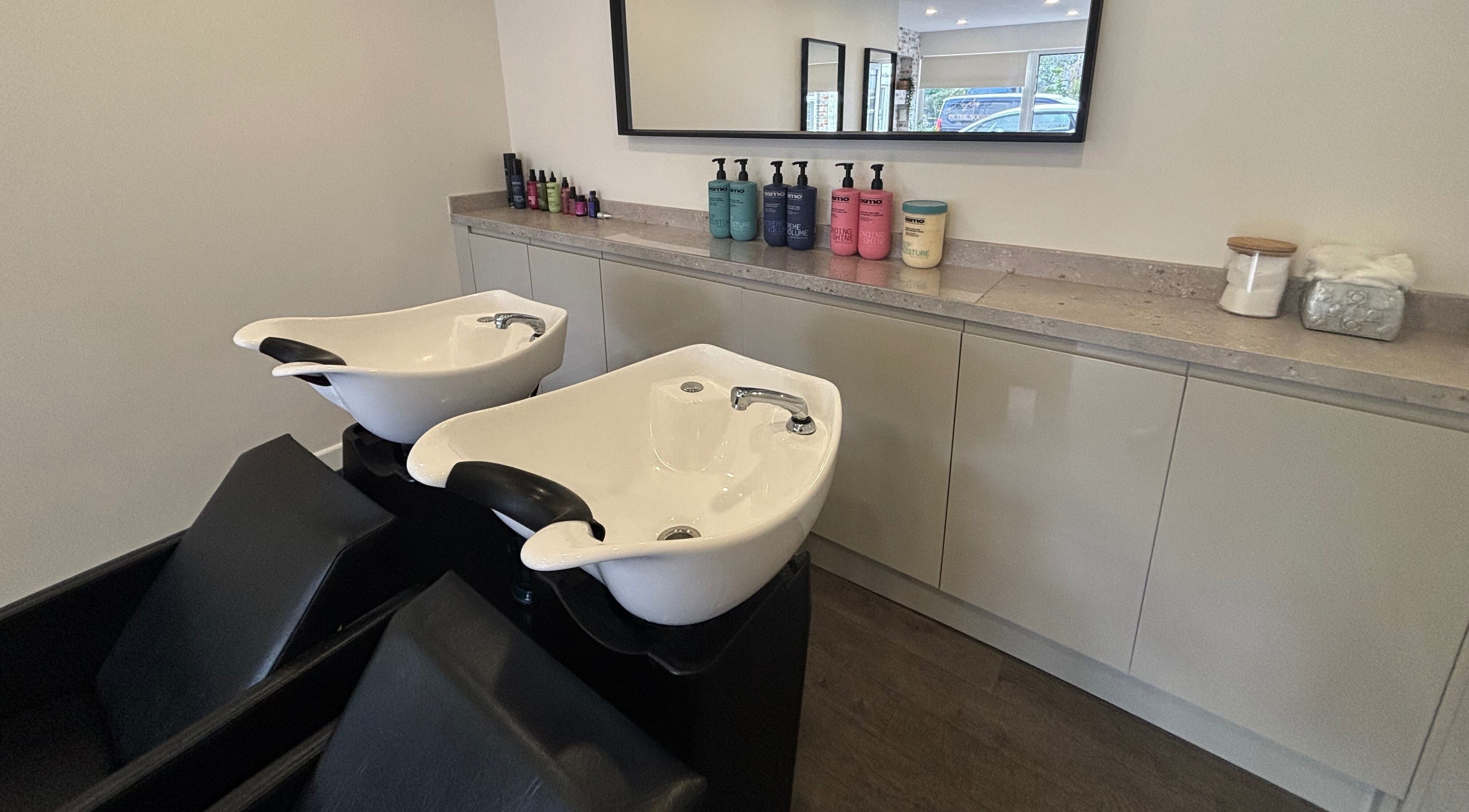 Modern wash stations at Salon In The Square, Mawnan Smith, England, GB, offering luxury haircare services.