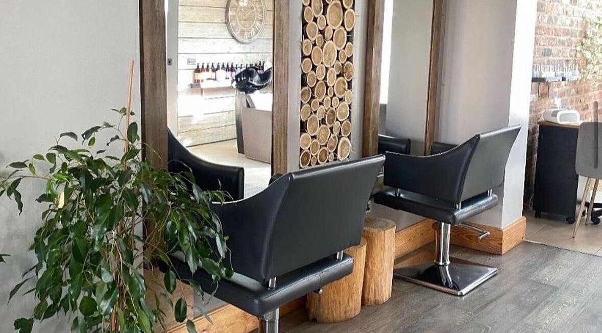 Modern salon chairs and wooden decor at Hair By Amy K in Freckleton, England, GB.