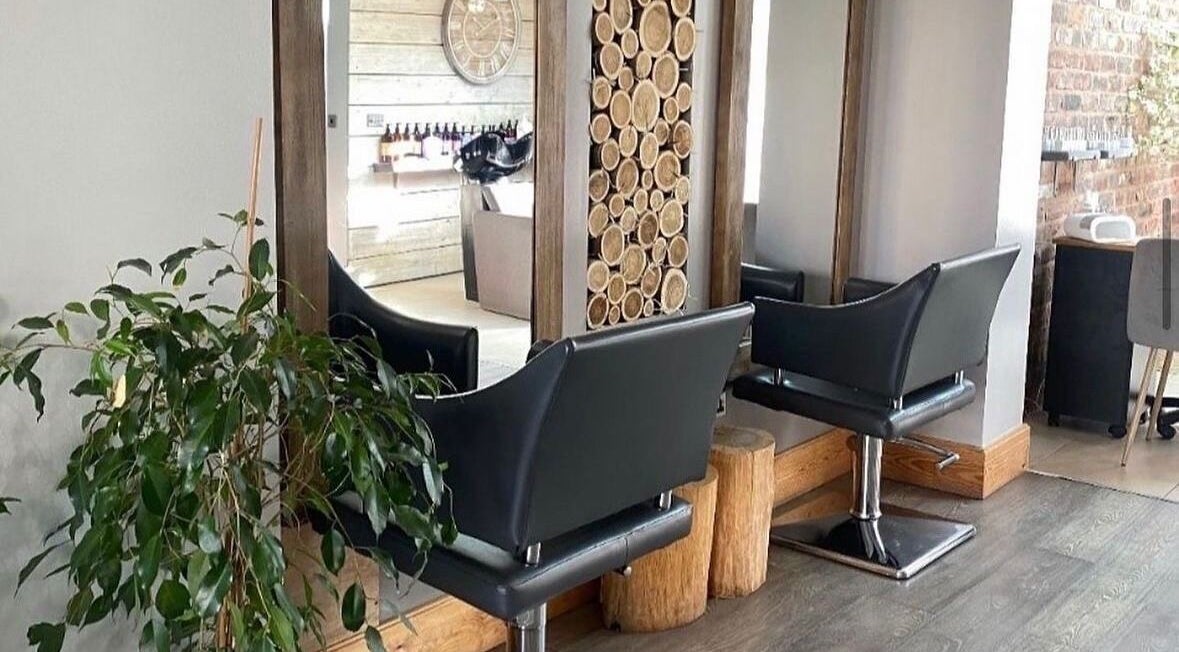 Modern salon chairs and wooden decor at Hair By Amy K in Freckleton, England, GB.