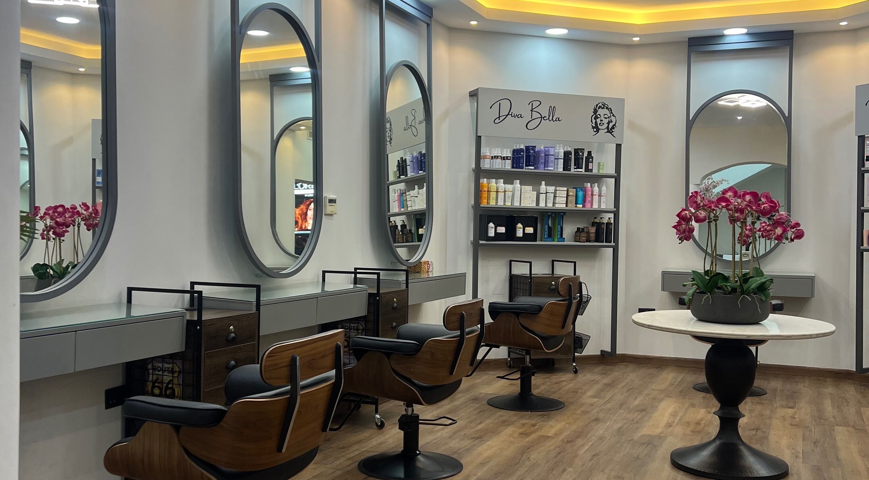 Chic interior of Diva Bella Beauty Center, Abu Dhabi, AE, featuring styling stations and lush decor.