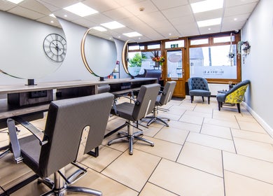 Modern salon interior at Rebecca Lee - The Salon, Swansea, SA4 6QD, GB, featuring stylish chairs and decor.