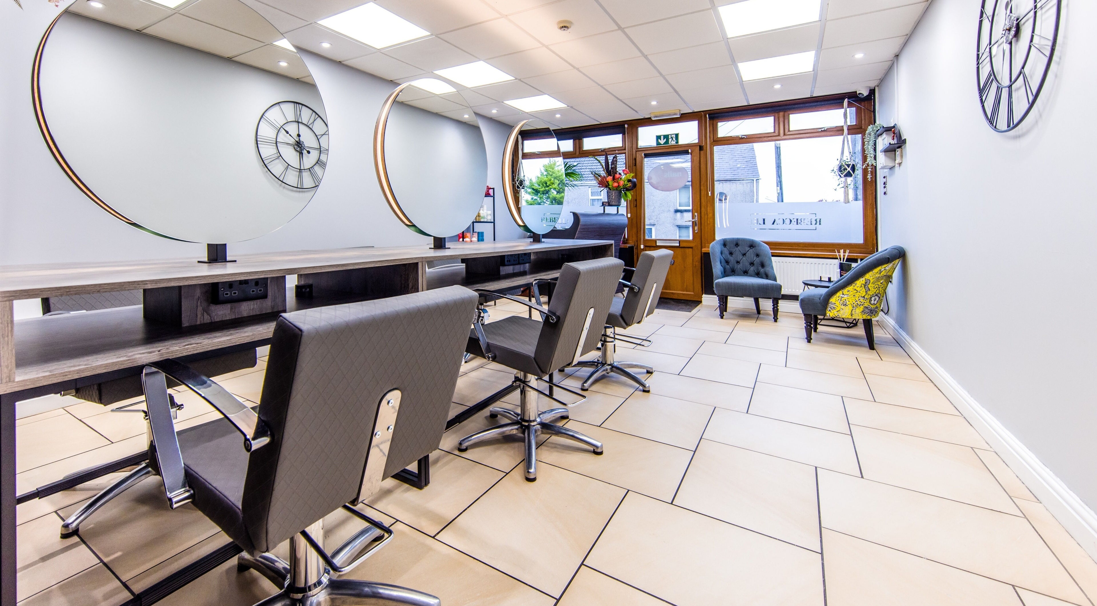 Modern salon interior at Rebecca Lee - The Salon, Swansea, SA4 6QD, GB, featuring stylish chairs and decor.