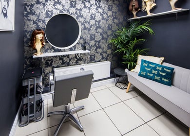 Chic styling area at Rebecca Lee - The Salon in Swansea, SA4 6QD, GB featuring a sleek chair and decor.