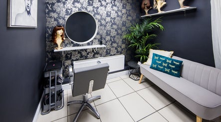 Chic styling area at Rebecca Lee - The Salon in Swansea, SA4 6QD, GB featuring a sleek chair and decor.
