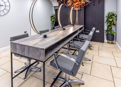 Modern styling area at Rebecca Lee - The Salon, Swansea, SA4 6QD, GB with sleek chairs and elegant mirrors.