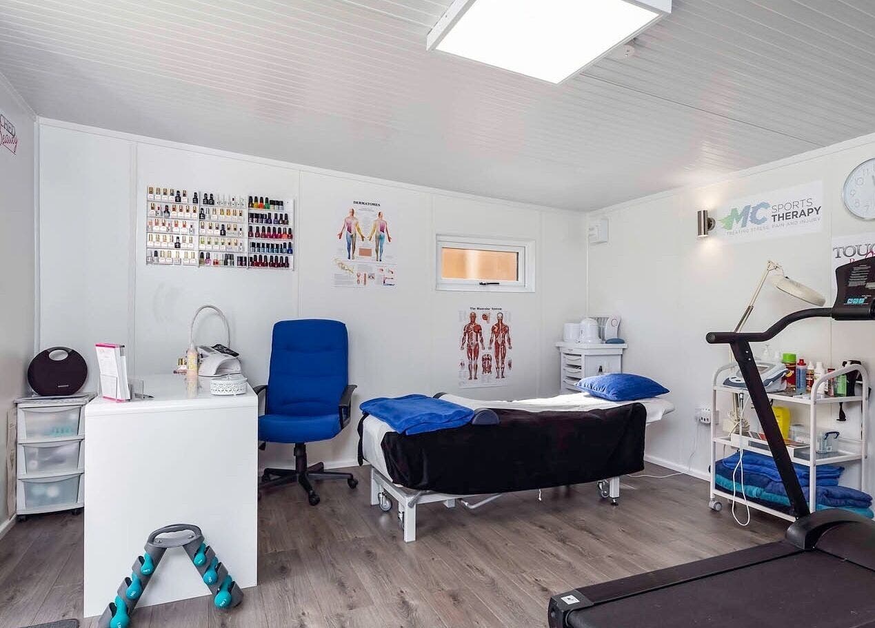 Relaxing therapy room at MC Sports Therapy, Stevenage, England, GB, featuring massage table and fitness equipment.