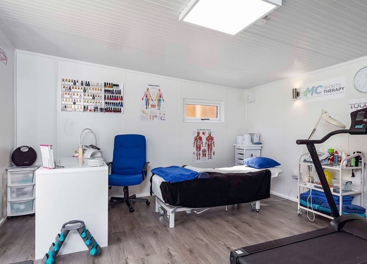 Relaxing therapy room at MC Sports Therapy, Stevenage, England, GB, featuring massage table and fitness equipment.