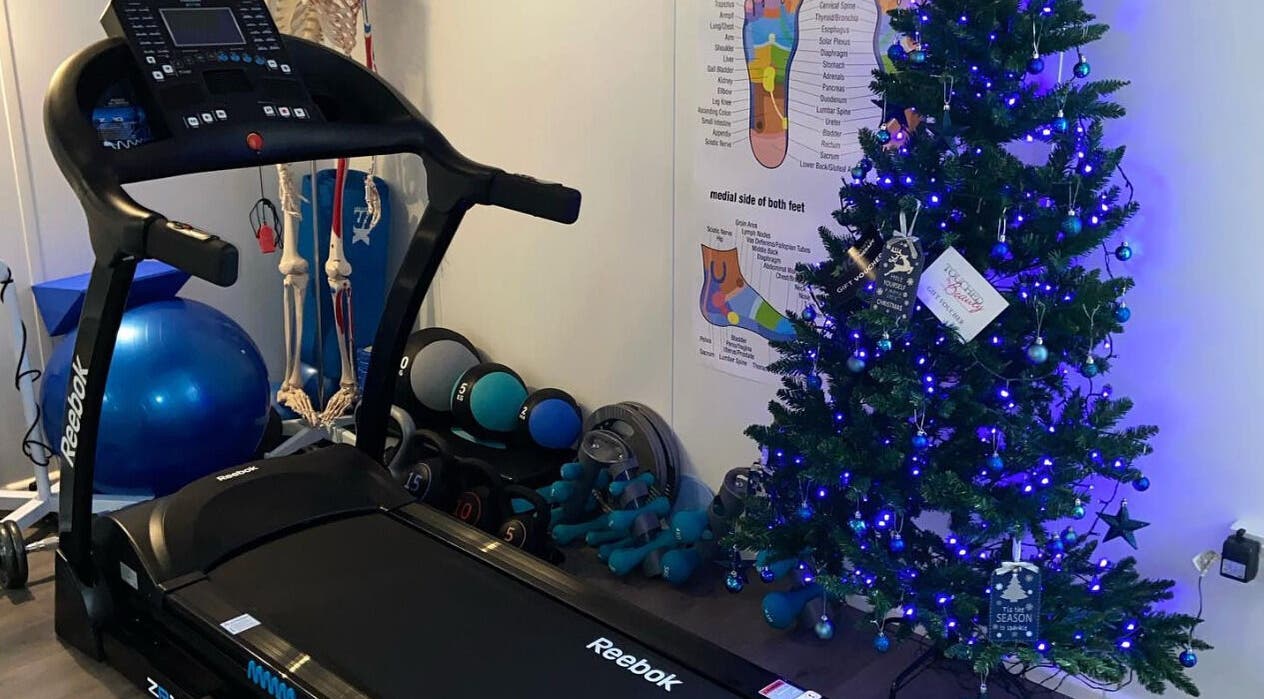 MC Sports Therapy in Stevenage, England features a treadmill and festive Christmas decorations.