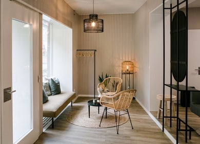 Cozy seating area at Marios Tsikrikas Hair Artist, Zürich, Zürich, CH, featuring elegant decor and soft lighting.