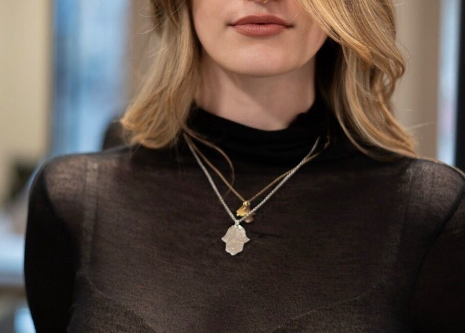 Stylish woman with necklace at Marios Tsikrikas Hair Artist, Zürich, Zürich, CH.