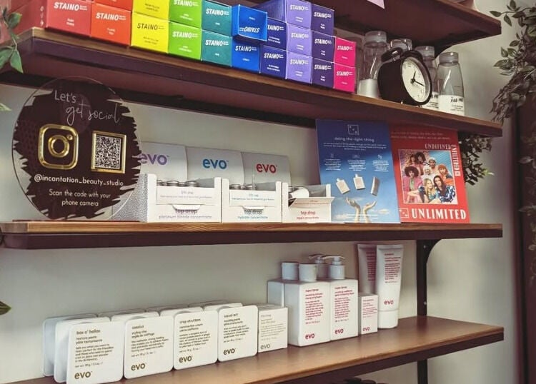 Elegant product shelves at Incantation Beauty Studio, Calgary, Alberta, CA showcasing vibrant beauty brands.