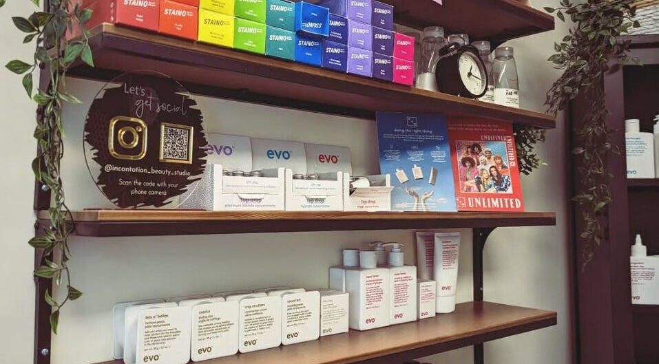 Elegant product shelves at Incantation Beauty Studio, Calgary, Alberta, CA showcasing vibrant beauty brands.