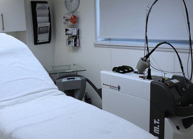 Modern treatment room at Strathearn Clinics in Glasgow, Scotland, GB features advanced laser equipment and a relaxing ambiance.