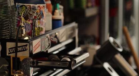 Vintage tool chest at Cutsmith in Yeadon, England, GB surrounded by decals and salon equipment.