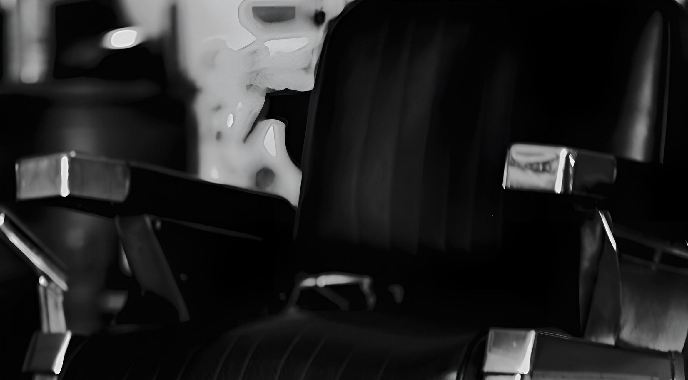 Elegant black barber chair at Cutsmith, Yeadon, England, GB. Sleek design and comfort for a luxury experience.