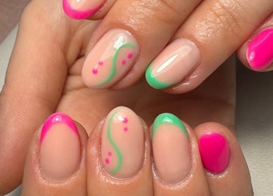 Stylish nail art with neon pink and green tips at True Nails, Glasgow, Scotland, GB.