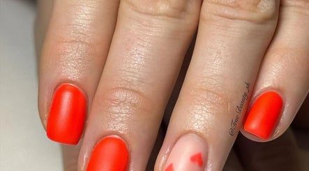 Vibrant red and pink nail art at True Nails in Glasgow, Scotland, GB.