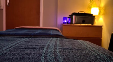 Laura Leongomez spa room in Neyland, Wales, GB with calming ambiance and soothing lighting.
