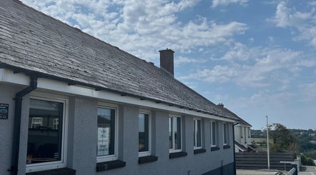 Charming exterior of Laura Leongomez in Neyland, Wales, GB, showcasing its unique slate roof design.