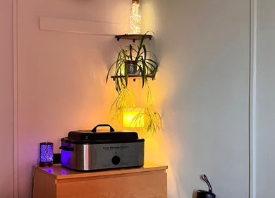 Relaxing massage setup at Laura Leongomez, Neyland, Wales, GB with warm lighting and plants.