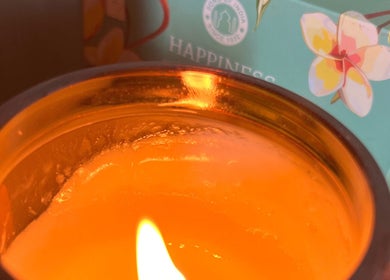 A lit candle providing a warm glow at Laura Leongomez in Neyland, Wales, GB.