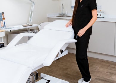 Modern treatment room at LS Aesthetics in Miskin, Wales, GB with a white spa bed and professional setup.
