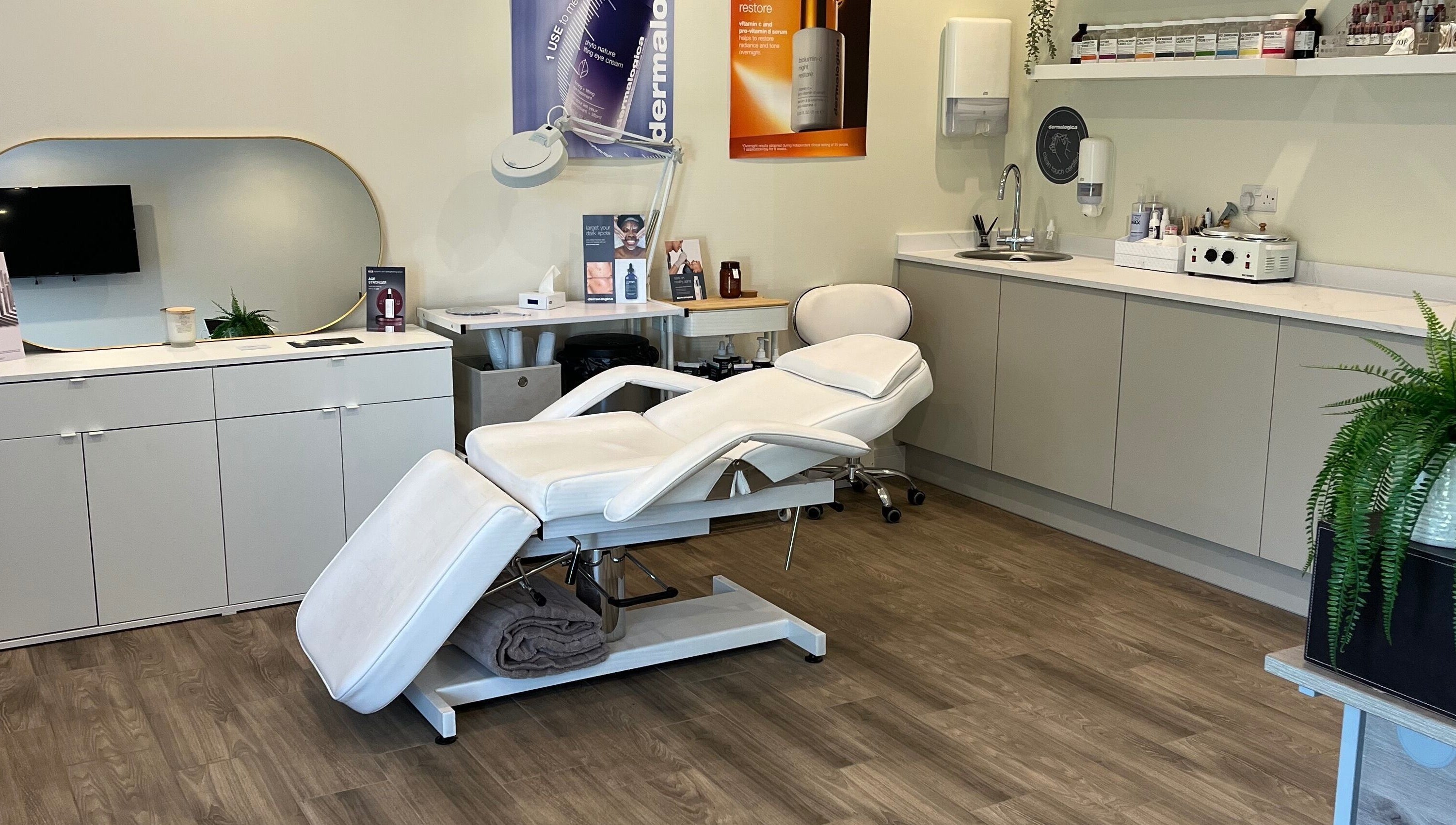 Modern treatment room at Ls Aesthetics, Miskin, Wales, GB featuring a plush white reclining chair.
