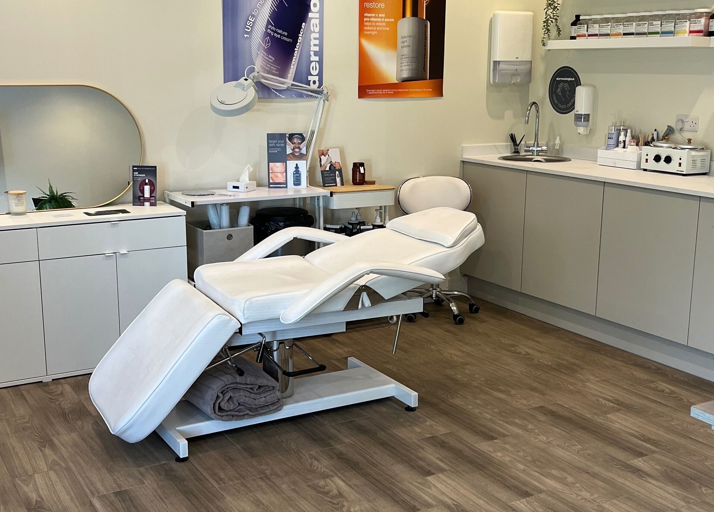 Modern treatment room at Ls Aesthetics, Miskin, Wales, GB featuring a plush white reclining chair.