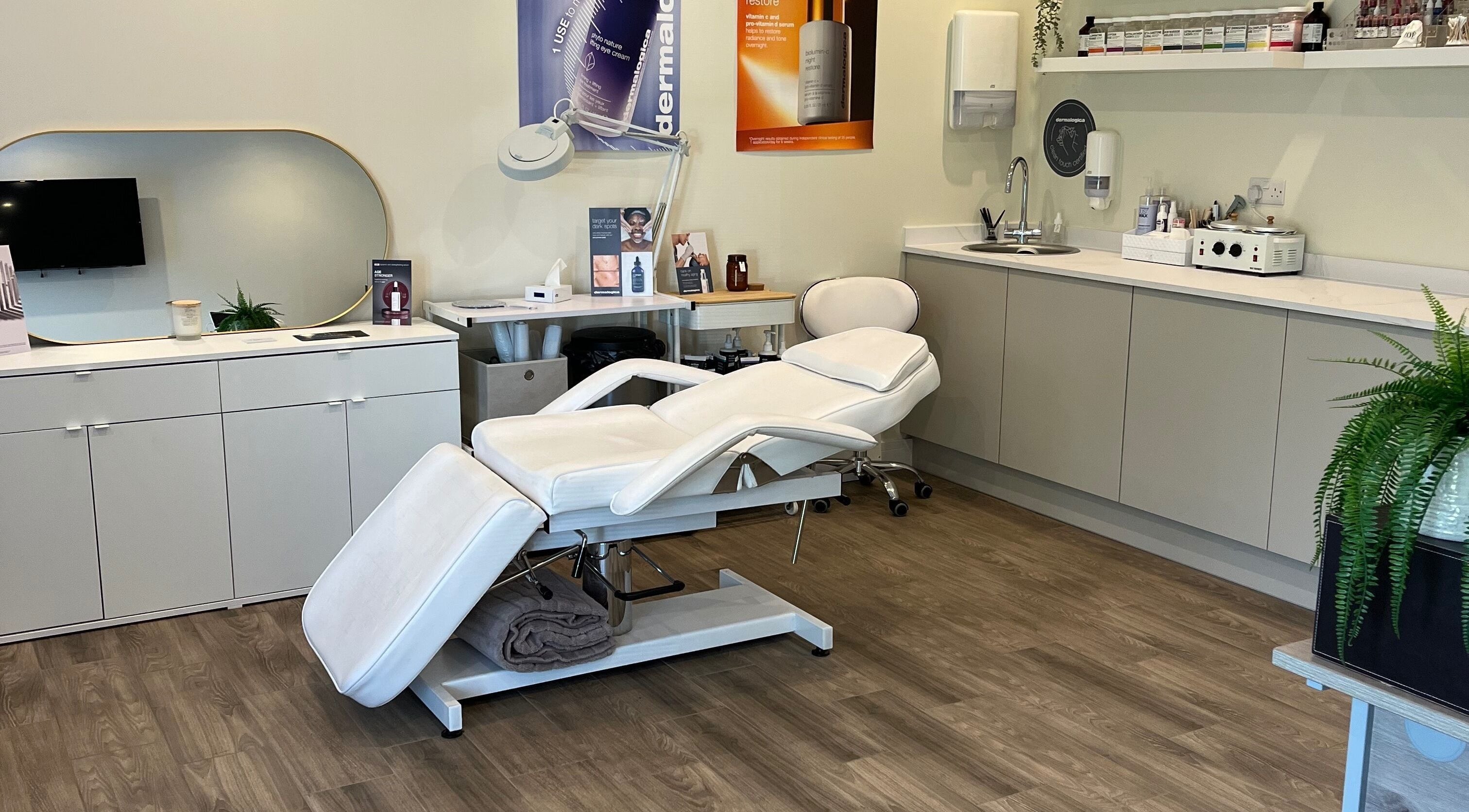 Modern treatment room at Ls Aesthetics, Miskin, Wales, GB featuring a plush white reclining chair.