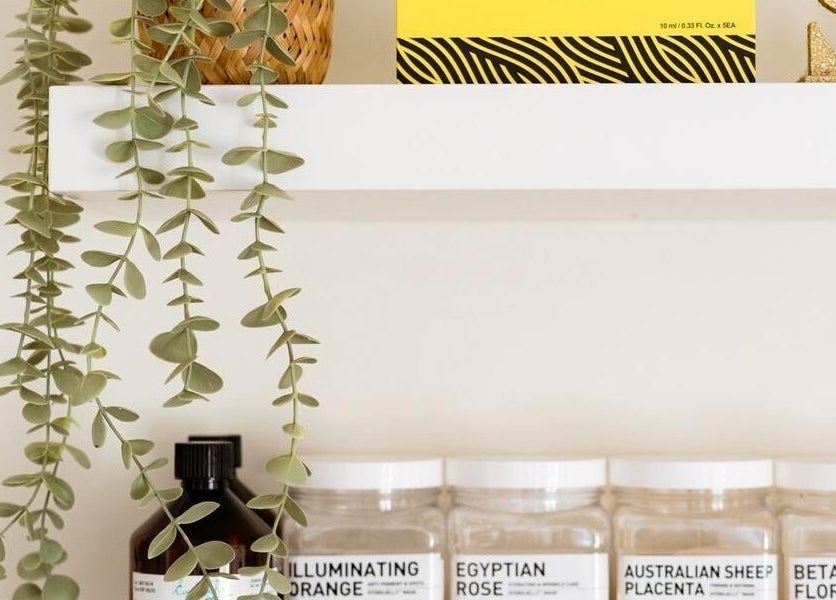 Products on a sleek shelf at Ls Aesthetics, Miskin, Wales, GB, showcasing a natural decorative touch.