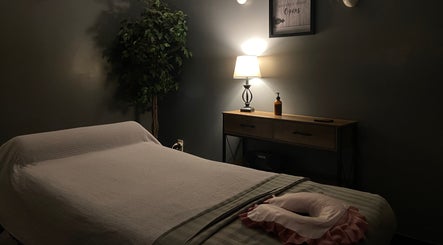 Soothing massage room at Zhenni Spa, Murfreesboro, Tennessee, US with soft lighting and cozy decor.
