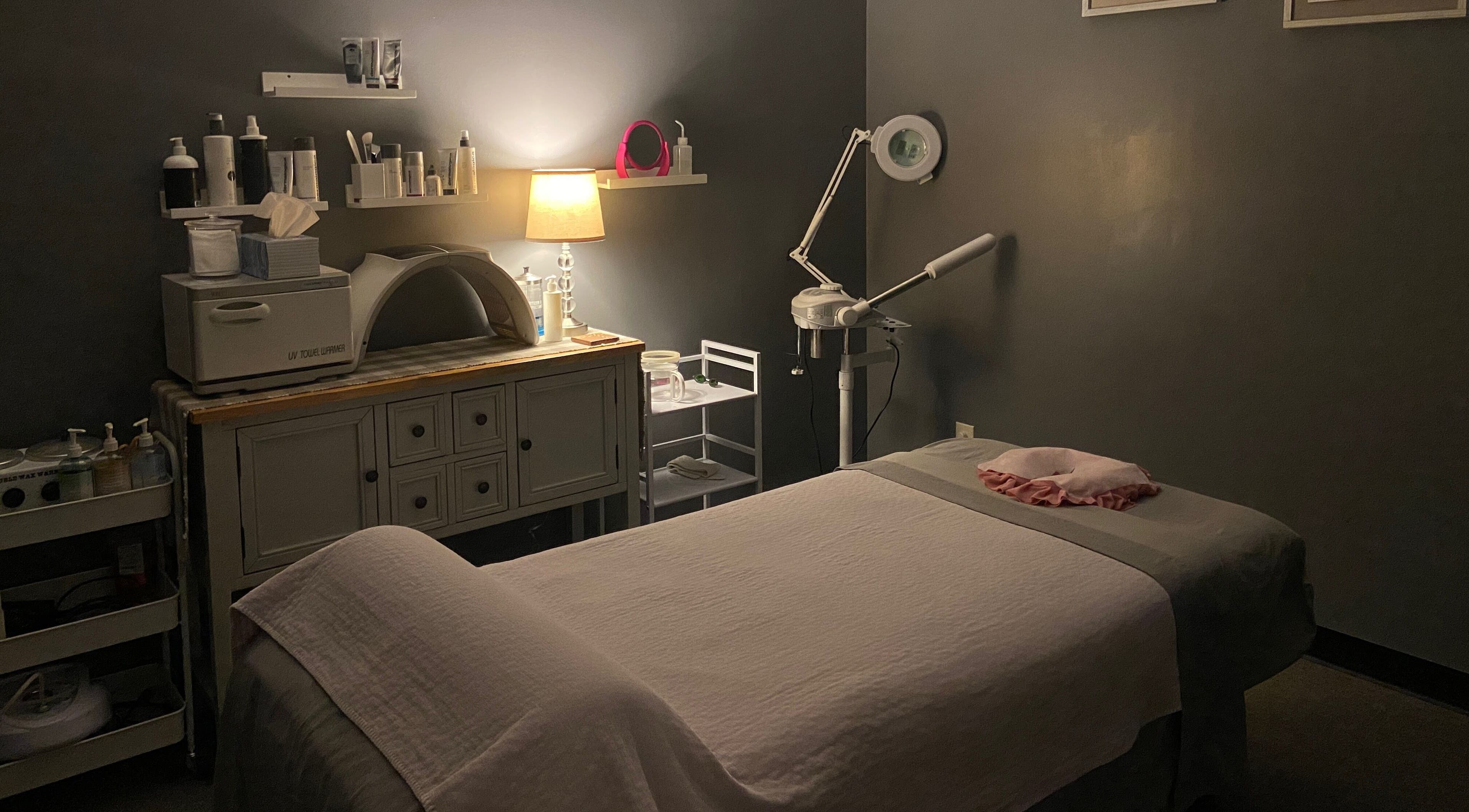 Relaxing spa treatment room at Zhenni Spa, Murfreesboro, Tennessee, US, featuring a massage bed and ambient lighting.