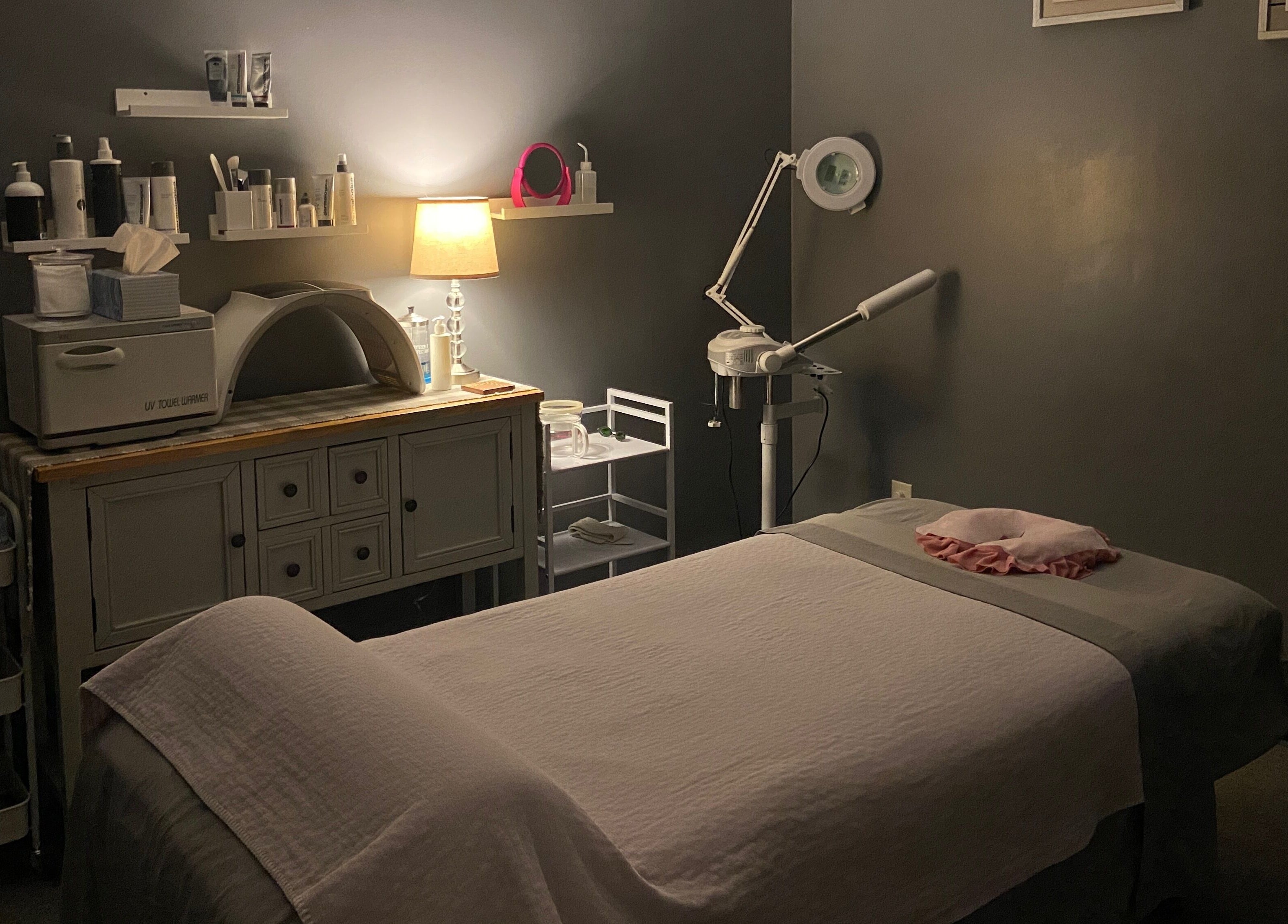 Cozy treatment room at Zhenni Spa in Murfreesboro, Tennessee, US, featuring a massage table and ambient lighting.