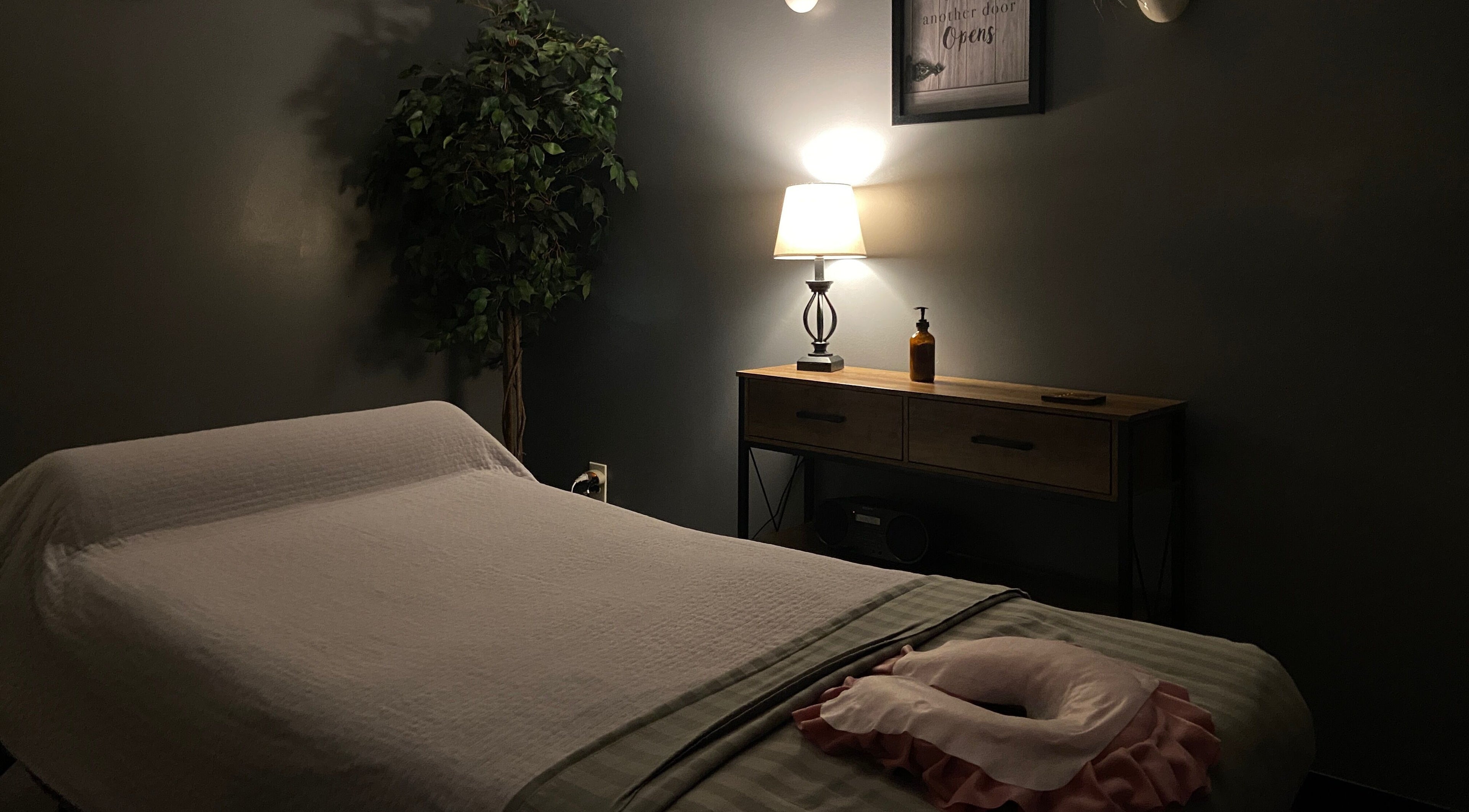 Tranquil massage room at Zhenni Spa, Murfreesboro, Tennessee, US, with soft lighting and cozy ambiance.