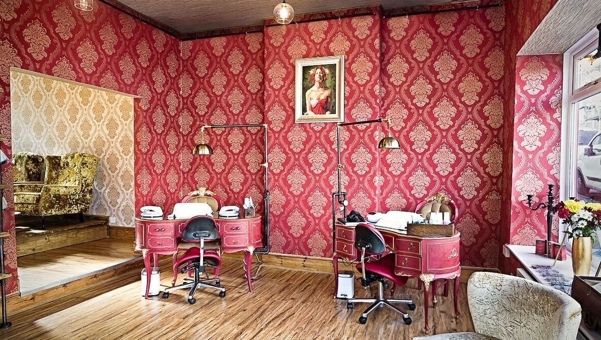 Luxurious beauty room at Gilded Dreams, Carnforth with red damask walls and vintage decor.