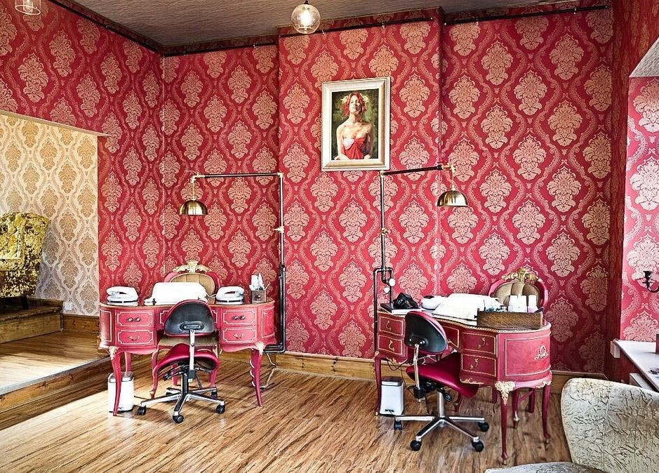 Luxurious beauty room at Gilded Dreams, Carnforth with red damask walls and vintage decor.