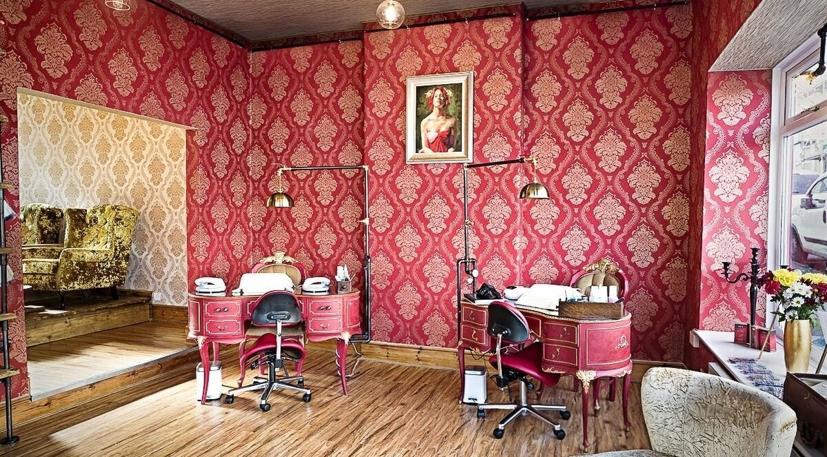 Luxurious beauty room at Gilded Dreams, Carnforth with red damask walls and vintage decor.