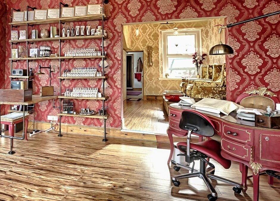 Luxurious red and gold interior of Gilded Dreams spa in Carnforth, England, GB showcasing elegant beauty salon decor.