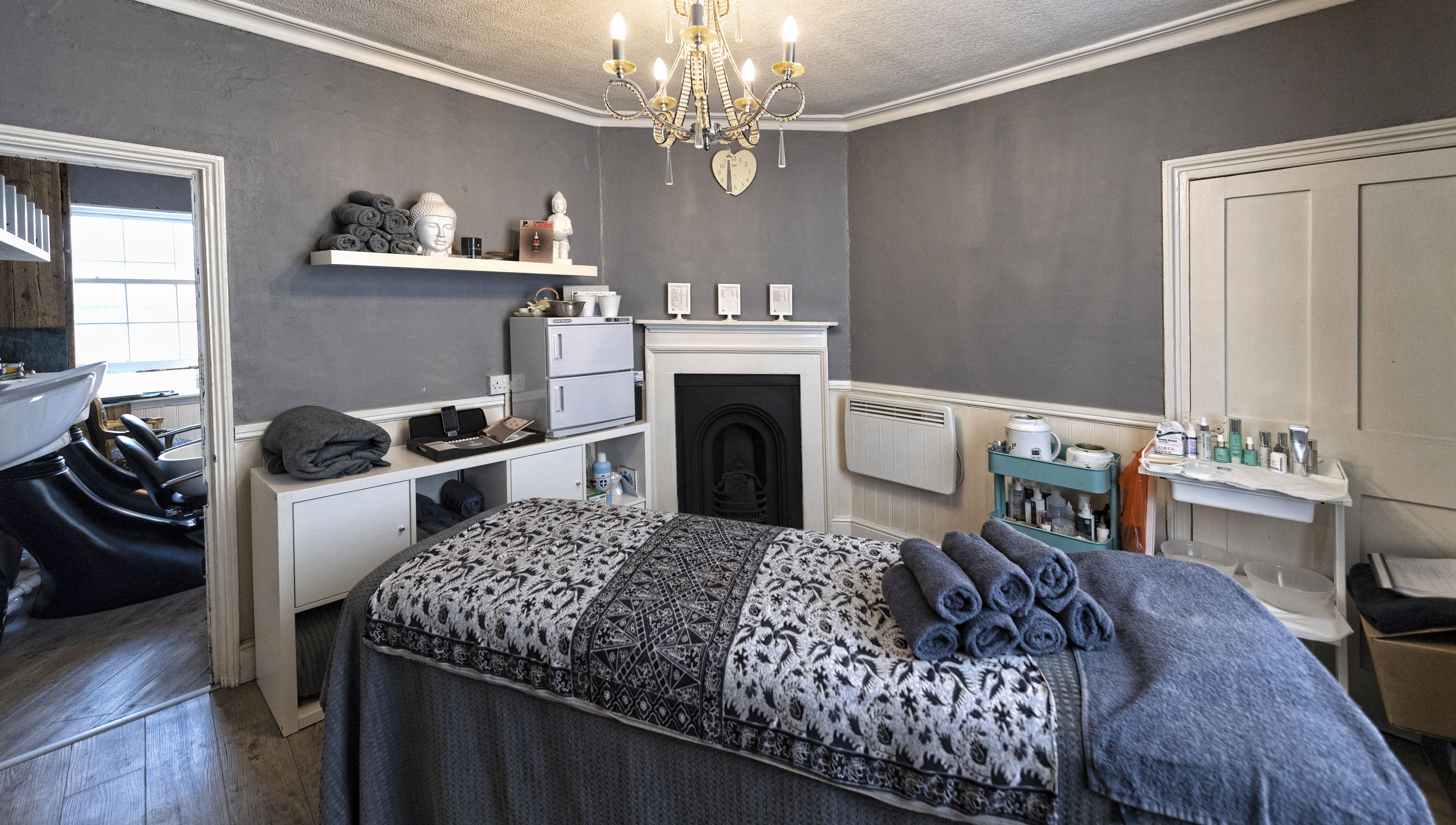 Cozy treatment room at Studio 6 in Hertford, England, GB featuring elegant decor and a massage table.