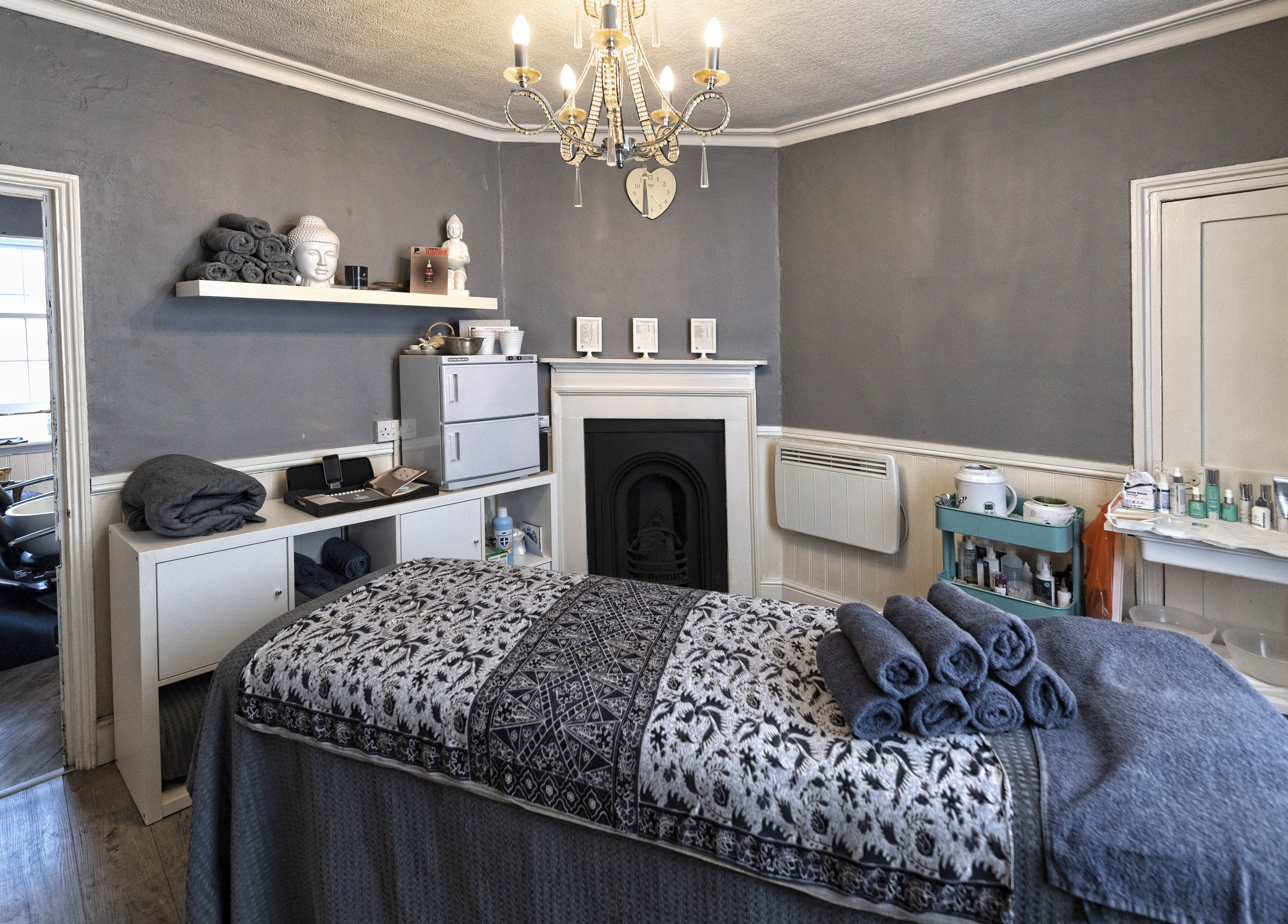 Cozy treatment room at Studio 6 in Hertford, England, GB featuring elegant decor and a massage table.