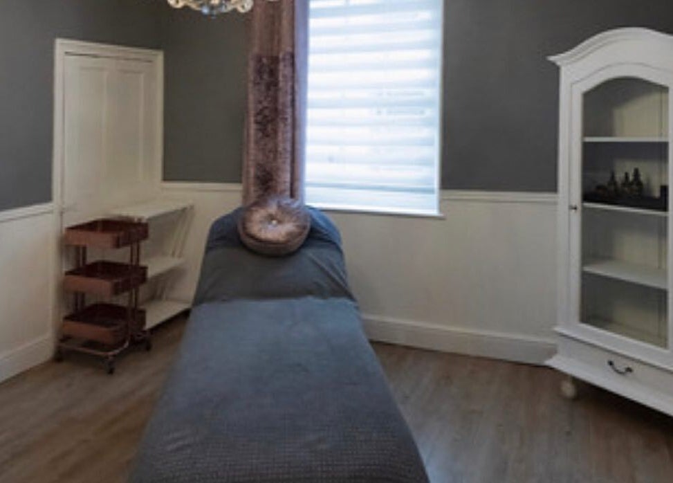 Cozy treatment room at Studio 6, Hertford, England, GB with a massage bed and elegant decor.