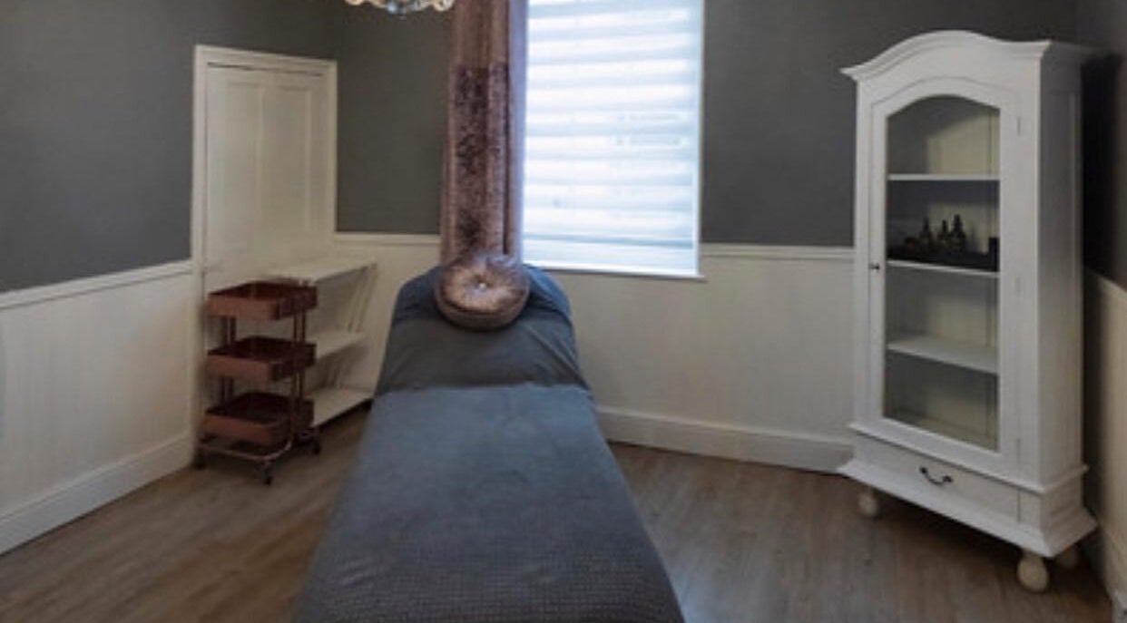Cozy treatment room at Studio 6, Hertford, England, GB with a massage bed and elegant decor.