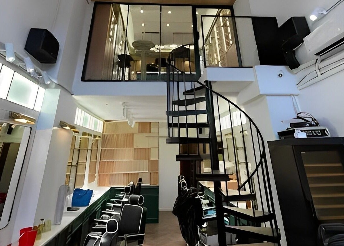 Interior of Canton Barber Wan Chai featuring sleek spiral staircase on Hong Kong Island, Hong Kong Island, HK.