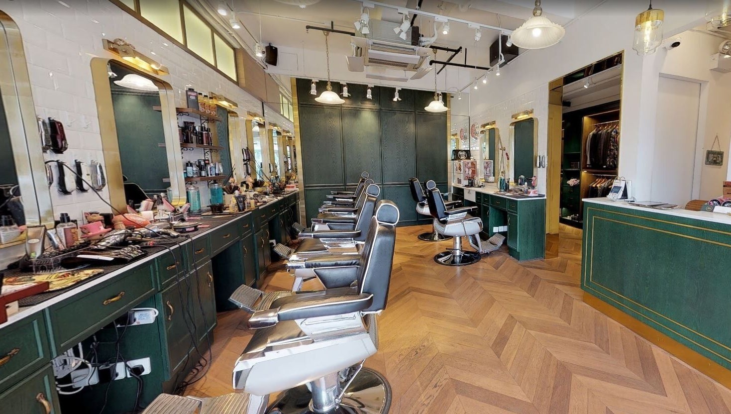 Interior view of Canton Barber Quarry Bay on Hong Kong Island, featuring sleek barber chairs and stylish decor.