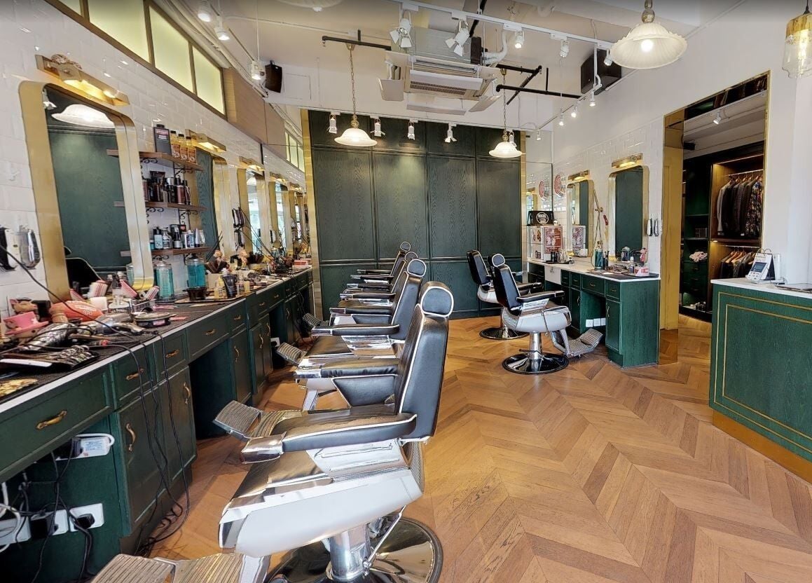 Interior view of Canton Barber Quarry Bay on Hong Kong Island, featuring sleek barber chairs and stylish decor.