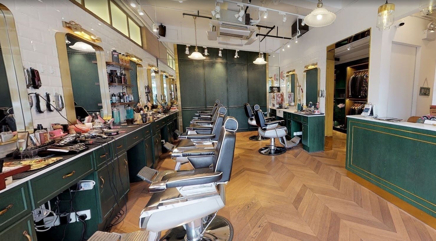 Interior view of Canton Barber Quarry Bay on Hong Kong Island, featuring sleek barber chairs and stylish decor.