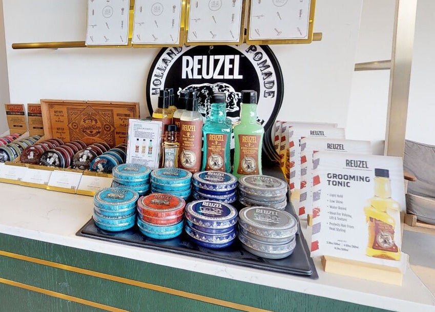 Display of grooming products at Canton Barber Quarry Bay, Hong Kong Island, HK showcasing diverse pomades and tonics.