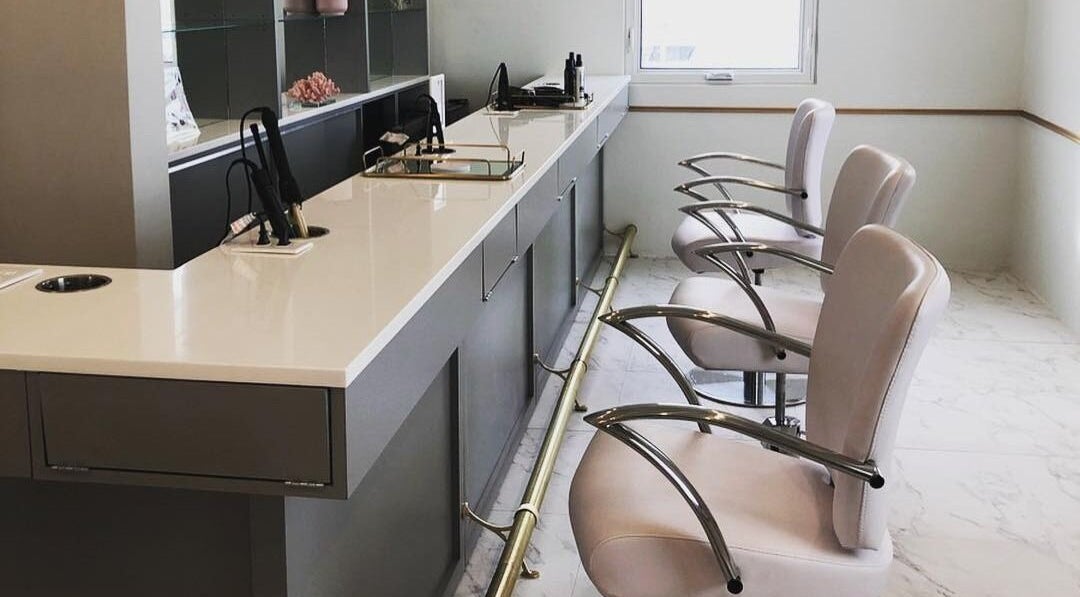 Modern salon chairs at Blowbar, San Juan, San Juan, PR, showcasing sleek design and elegance.