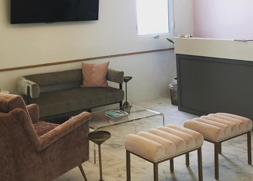 Elegant seating at Blowbar, San Juan, San Juan, PR, featuring plush chairs and a modern reception desk.